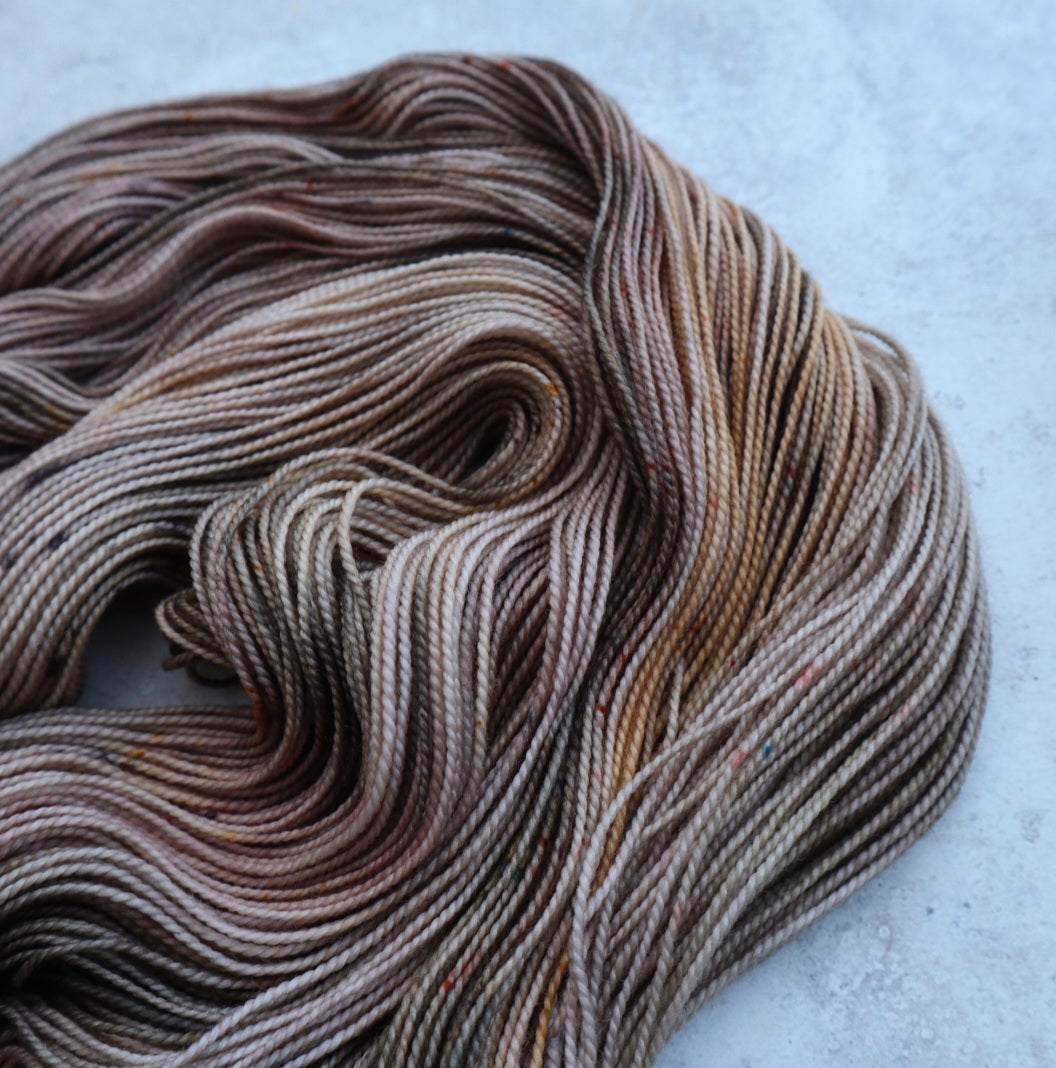 Yarn in grays, greens and golds.
