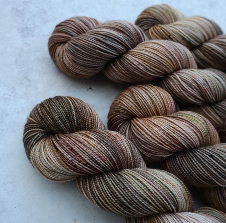 Yarn in grays, greens and golds.
