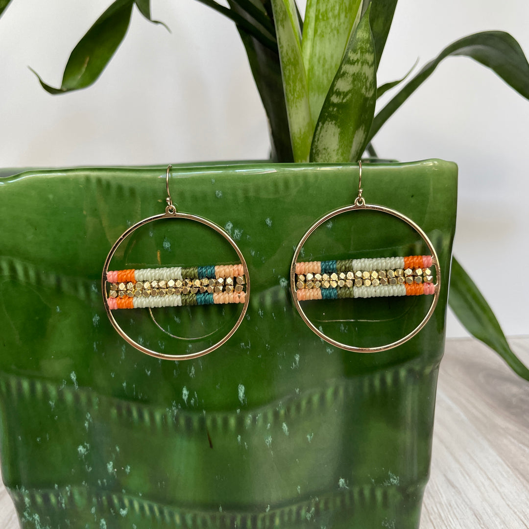 Macrame and beaded earrings in teal, aqua and orange.