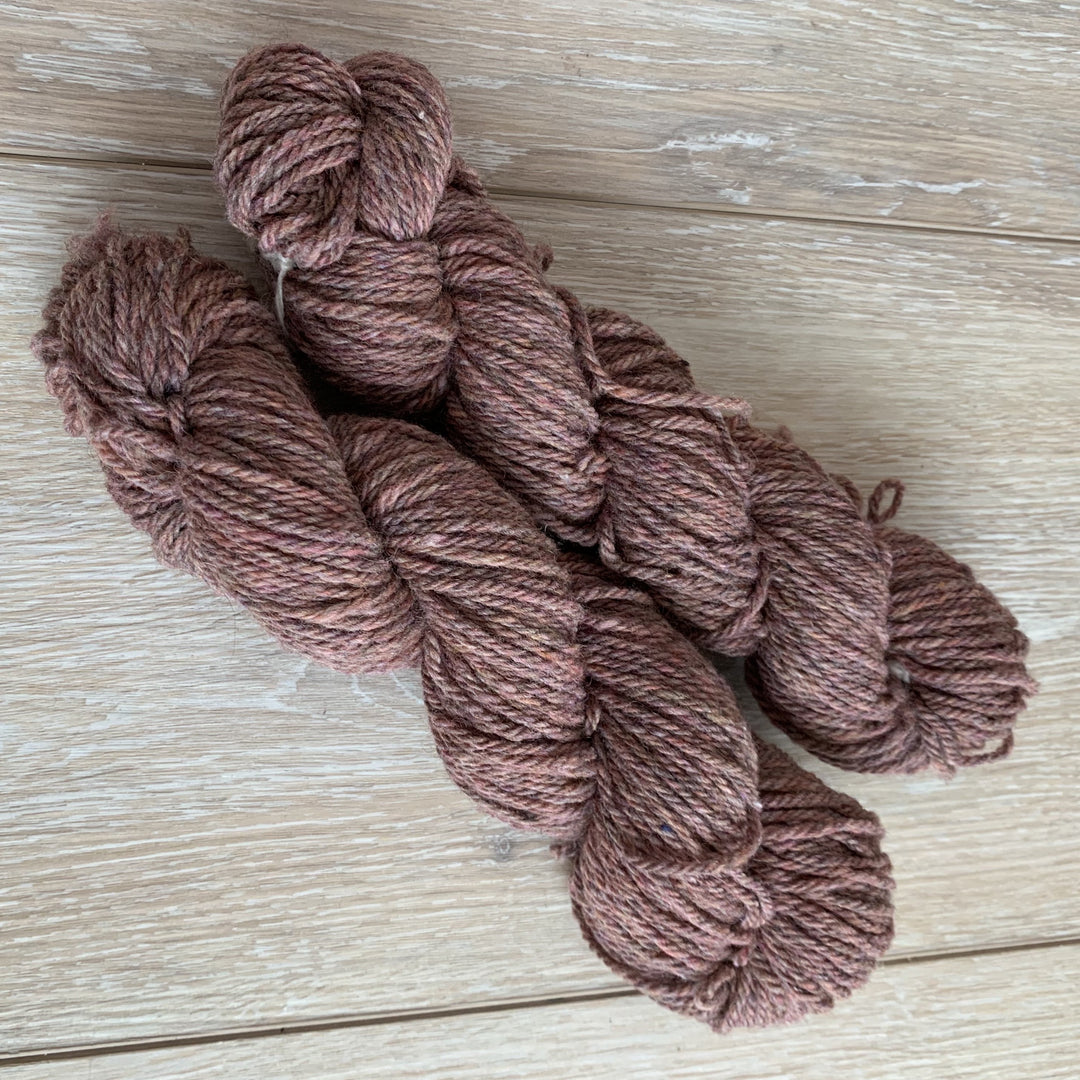 Skeins of dusty pink yarn.
