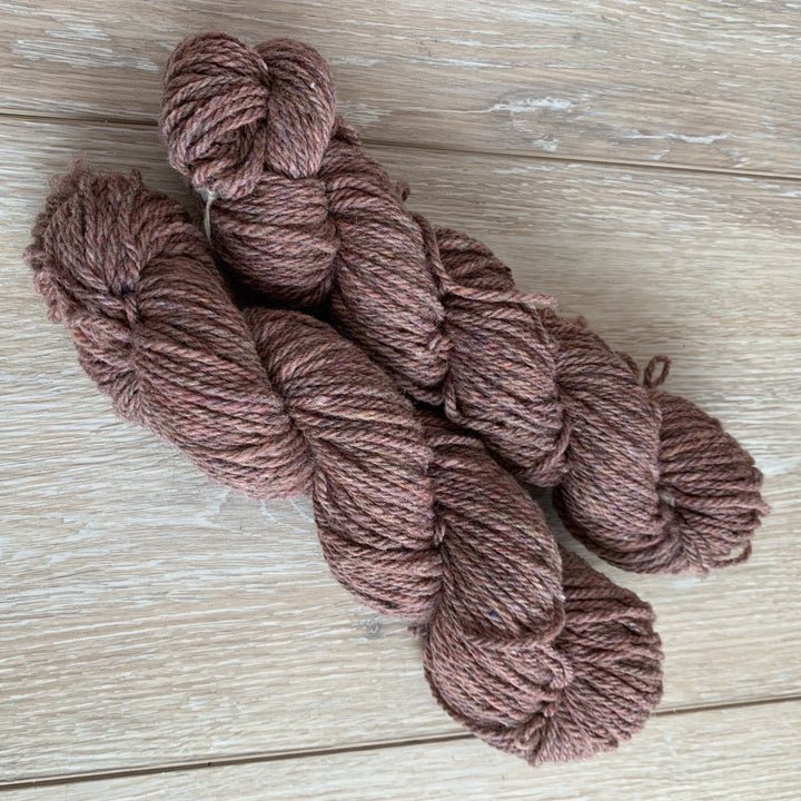 Skeins of dusty pink yarn.