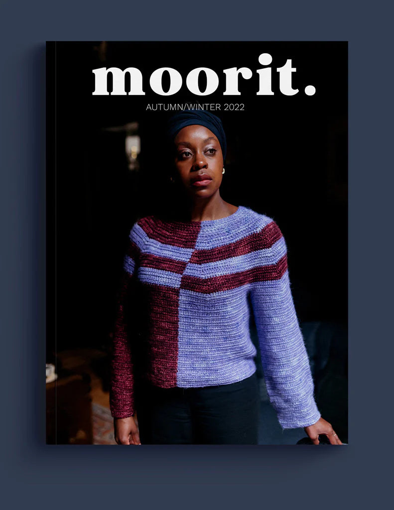 A brown-skinned woman wearing a lilac and brown crocheted sweater on the cover of Moorit.