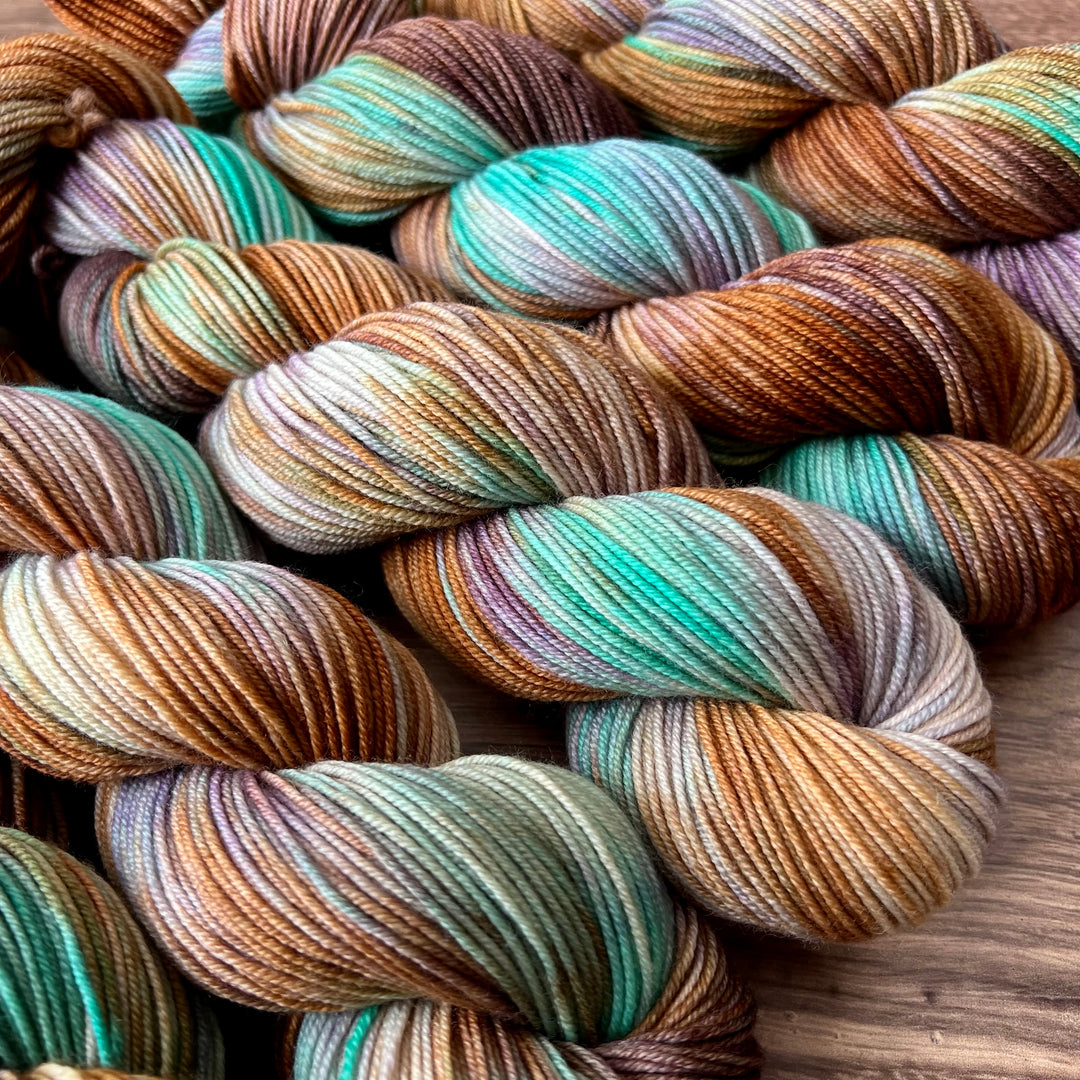 Twisted hanks of yarn in blue, purple, pink orange and teal.