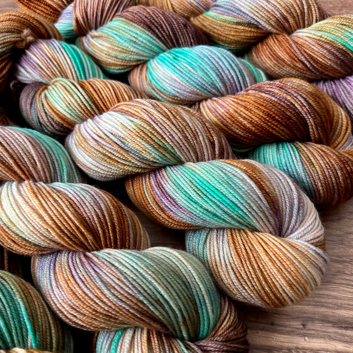 Twisted hanks of yarn in blue, purple, pink orange and teal.