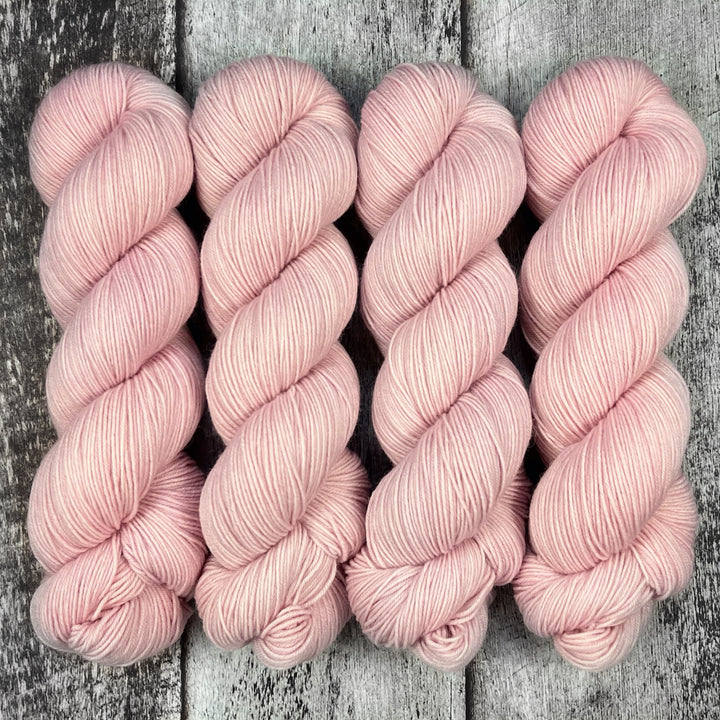 Skeins of pale pink yarn.