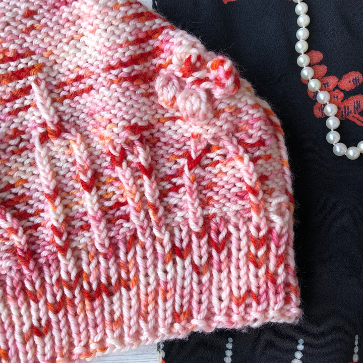 A red and orange speckled hat.