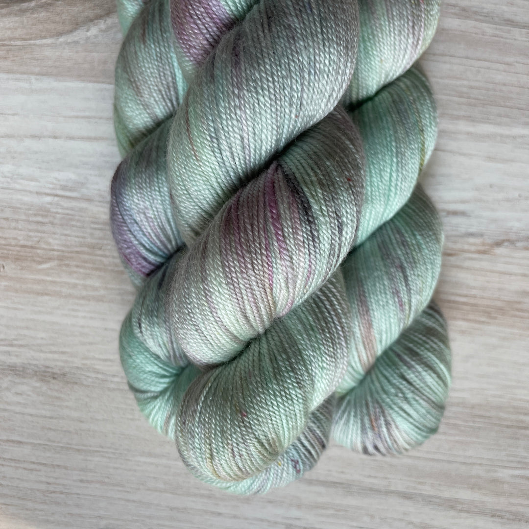 Mint green yarn speckled with purple.