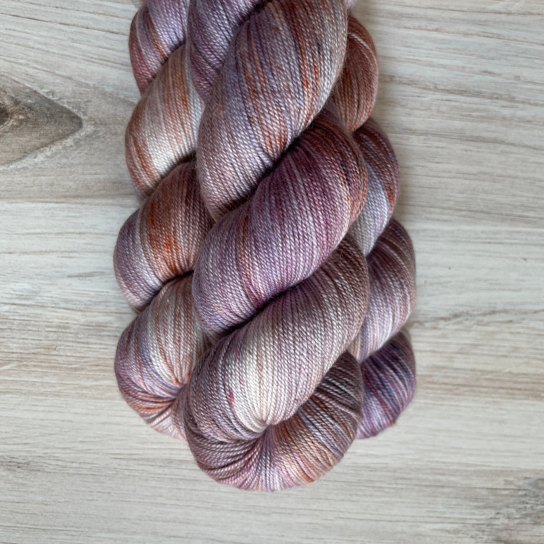 Yarn speckled with purple, orange and gray.