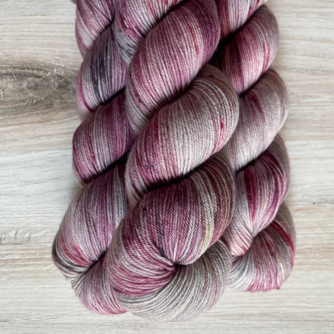 Gray yarn speckled with purple.