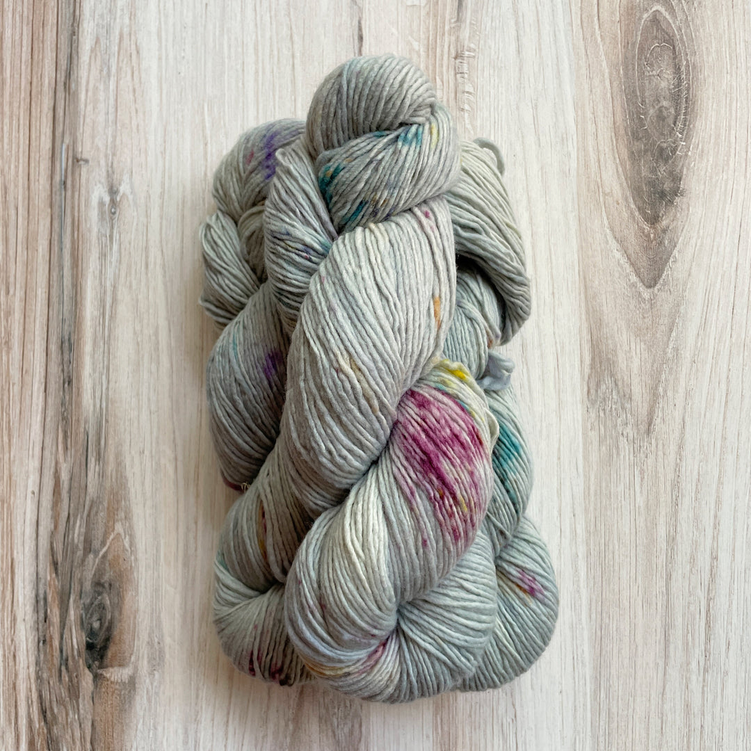 Blue yarn speckled with purple.