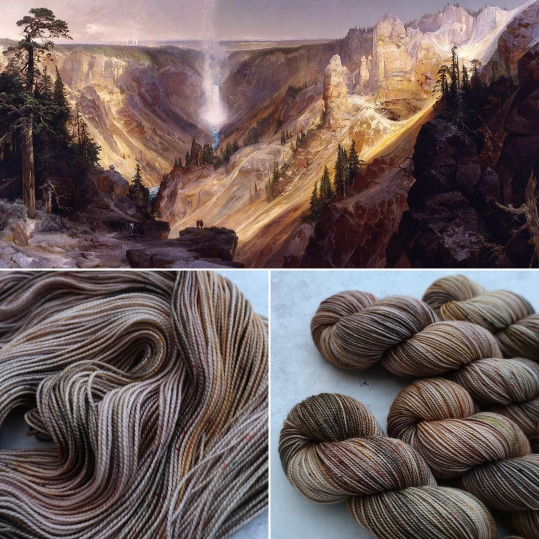 A painting of a canyon and waterfall in grays, greens and golds and yarn in similar colors.