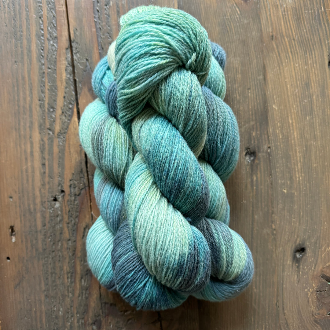 Skeins of light blue/green variegated yarn.