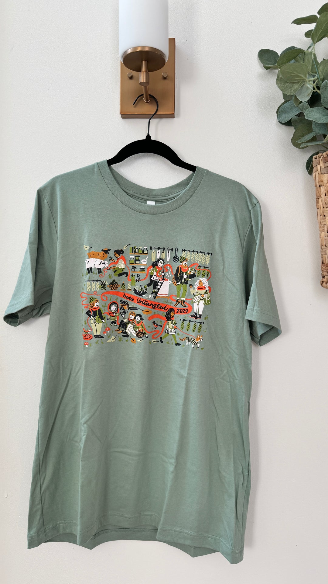 A green t-shirt with the Indie Untangled 2024 design.