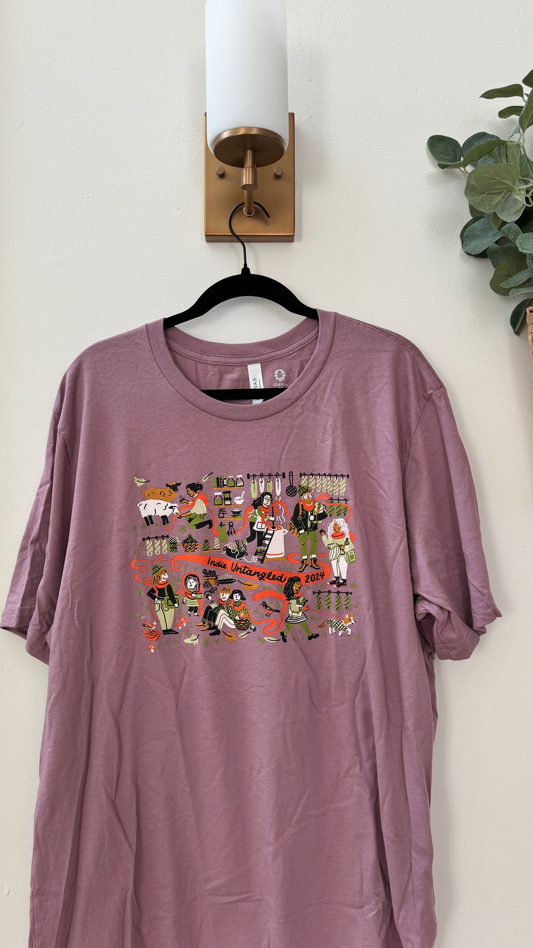 A purple t-shirt with the Indie Untangled 2024 design.