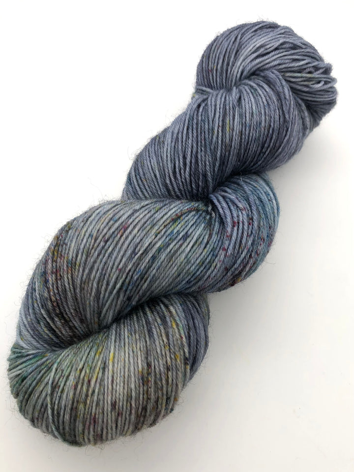 A skein of blue, green and brown speckled yarn.