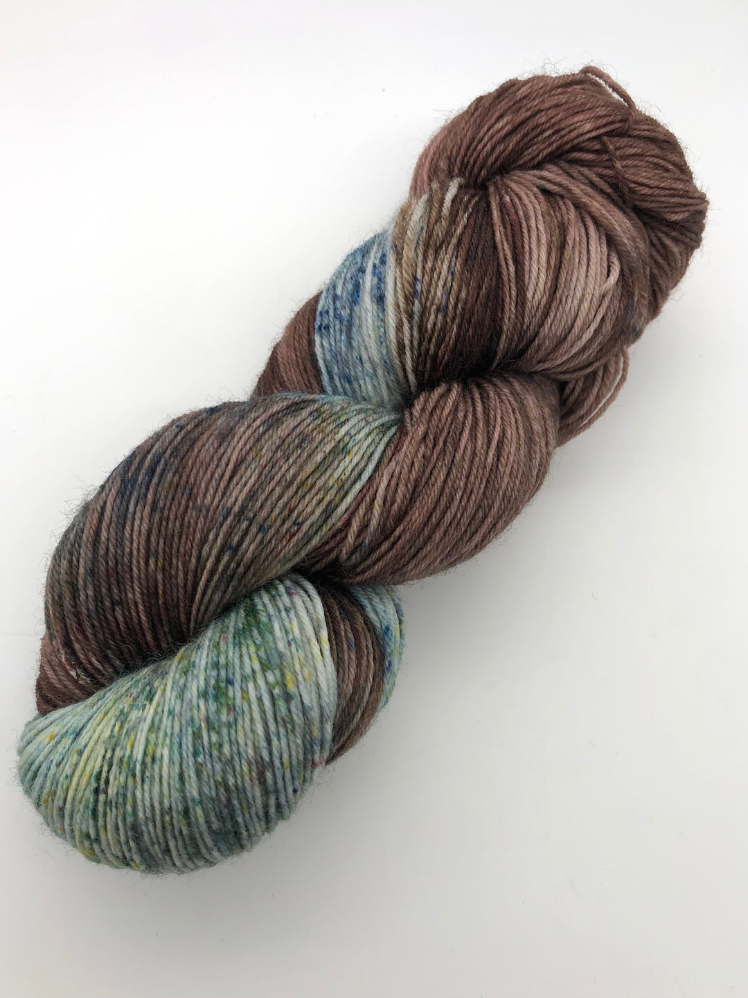 A skein of blue, green and brown speckled yarn.