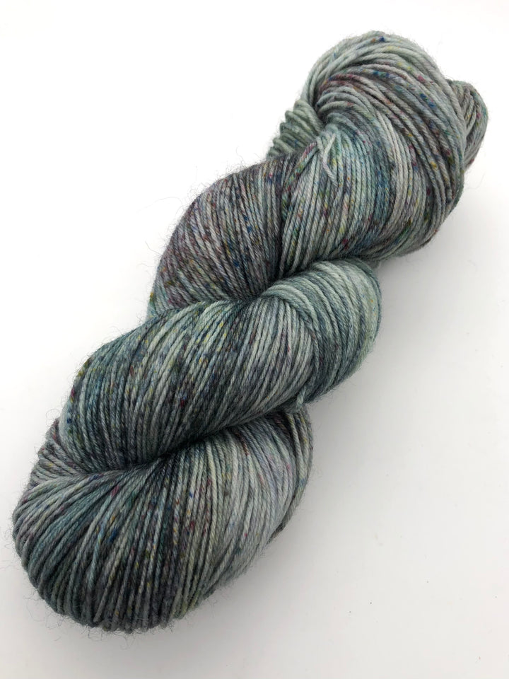 A skein of blue, green and brown speckled yarn.