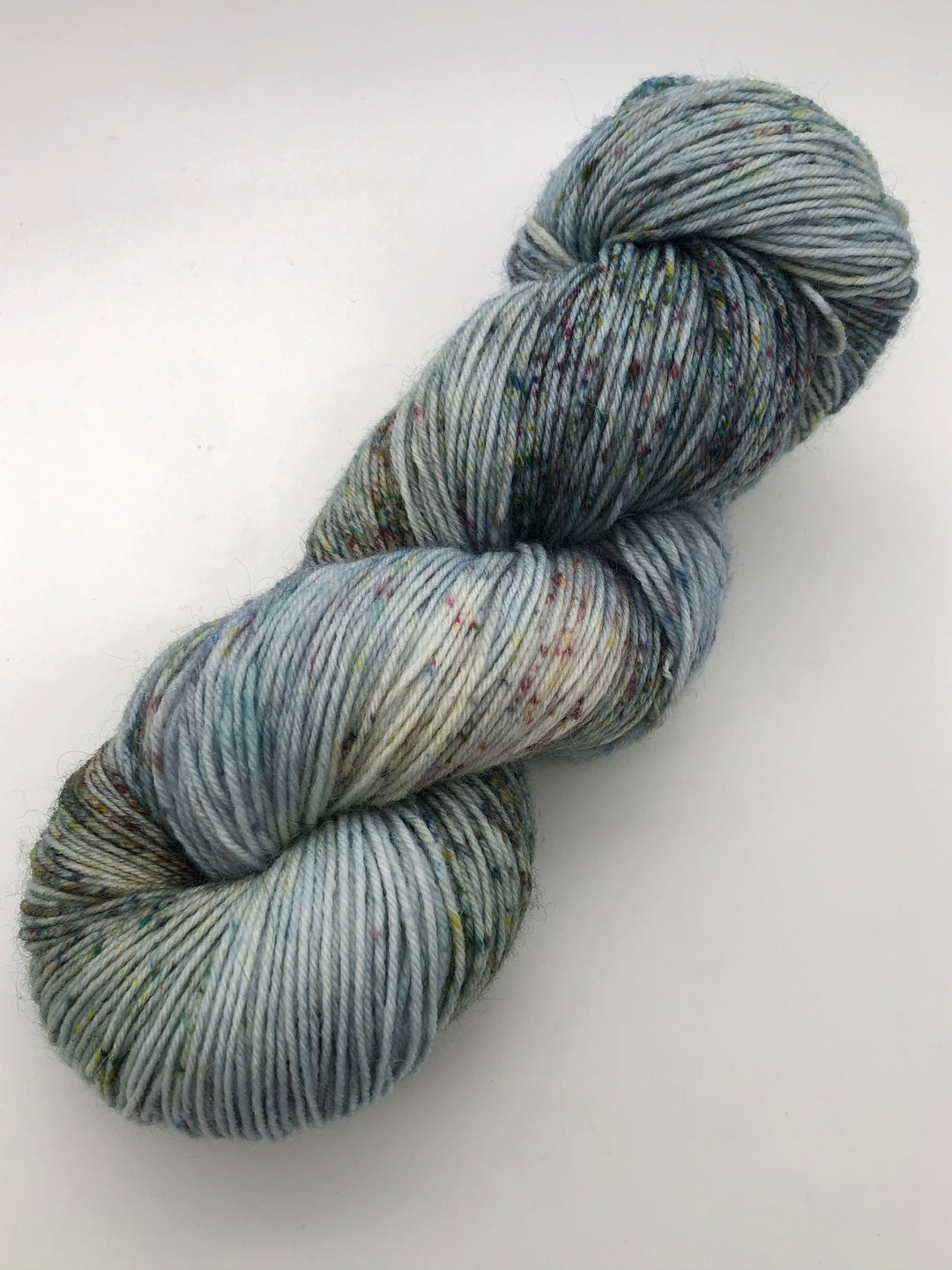 A skein of blue, green and brown speckled yarn.