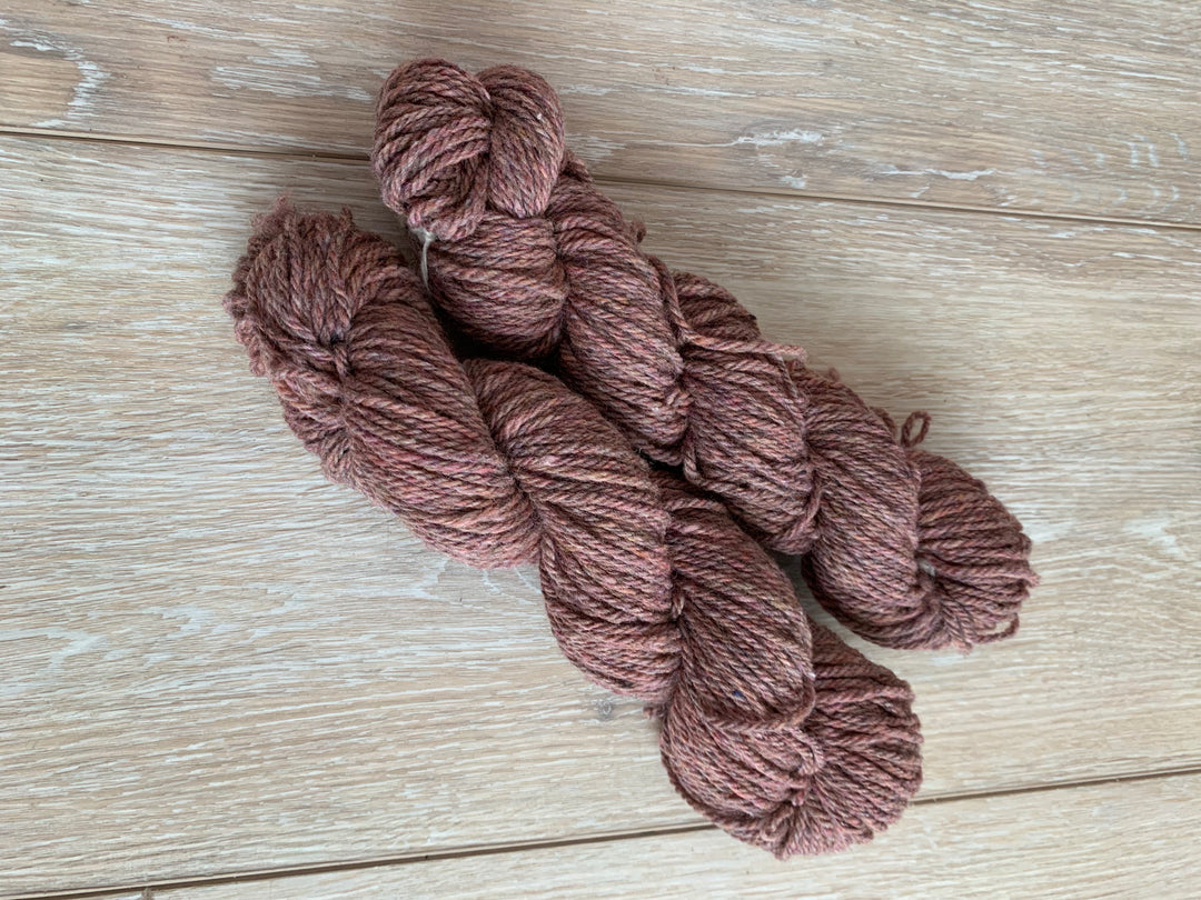 Twisted skeins of pink rustic yarn.