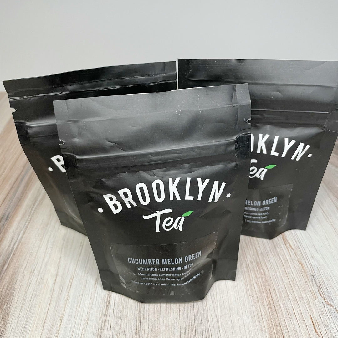Three black pouches that read Brooklyn Tea, Cucumber Melon Green.