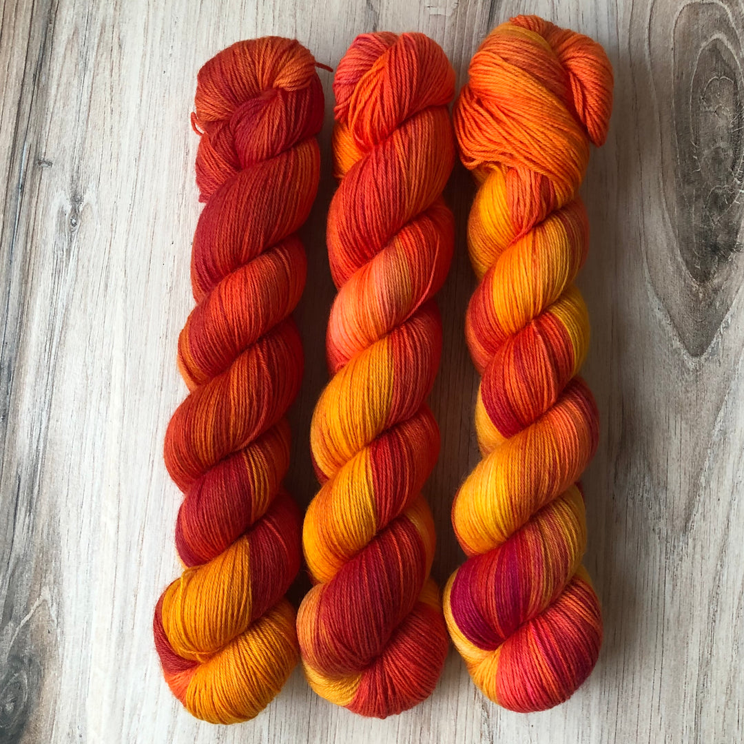 Skeins of red and orange variegated yarn.