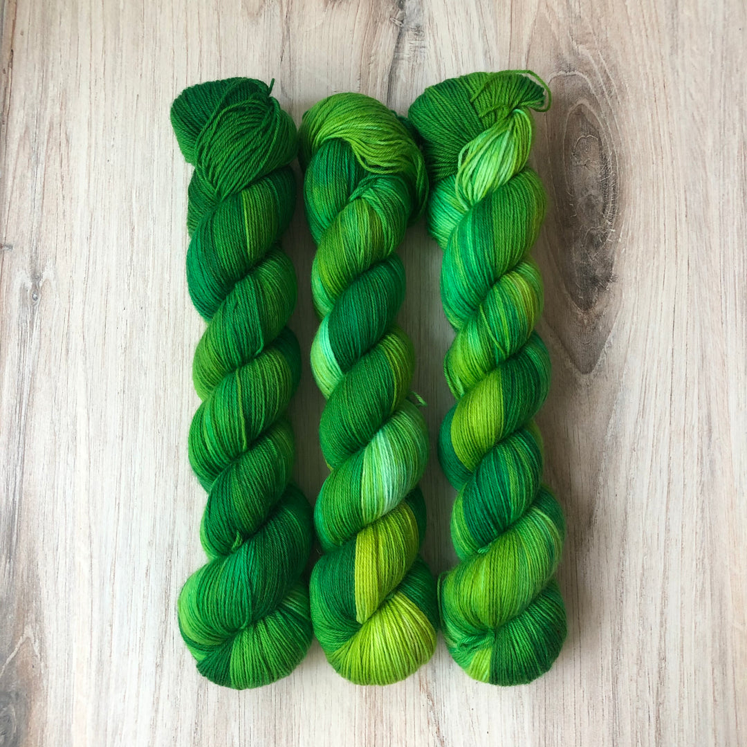 Twisted skeins of bright green yarn.