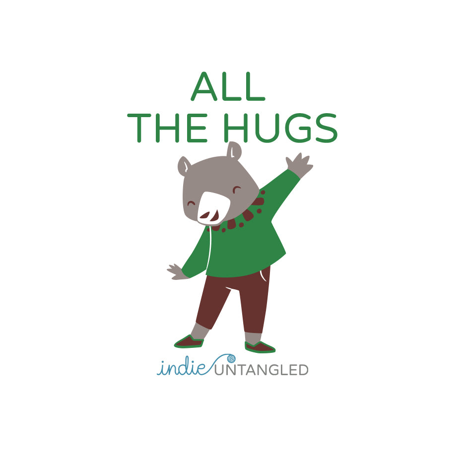 A bear wearing a green sweater and the words All the hugs.