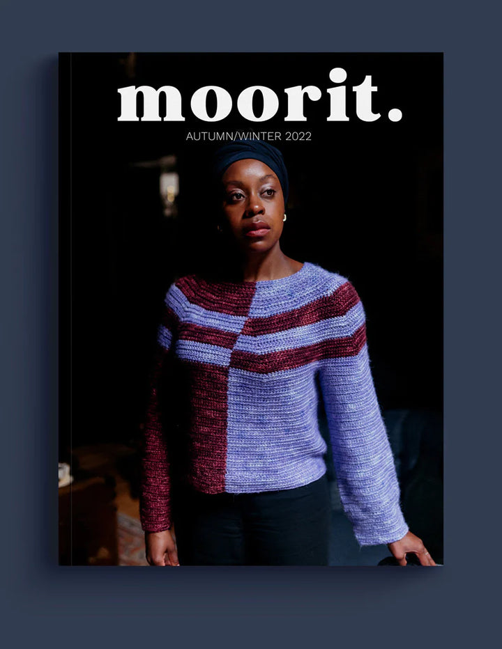 A brown-skinned woman wearing a lilac and brown crocheted sweater on the cover of Moorit.