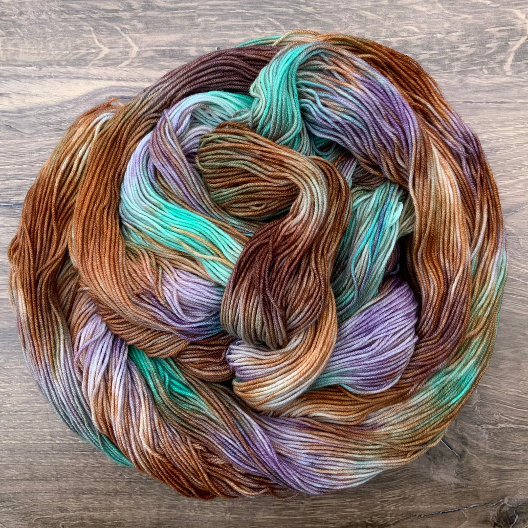 Untwisted hanks of yarn in blue, purple, pink orange and teal.