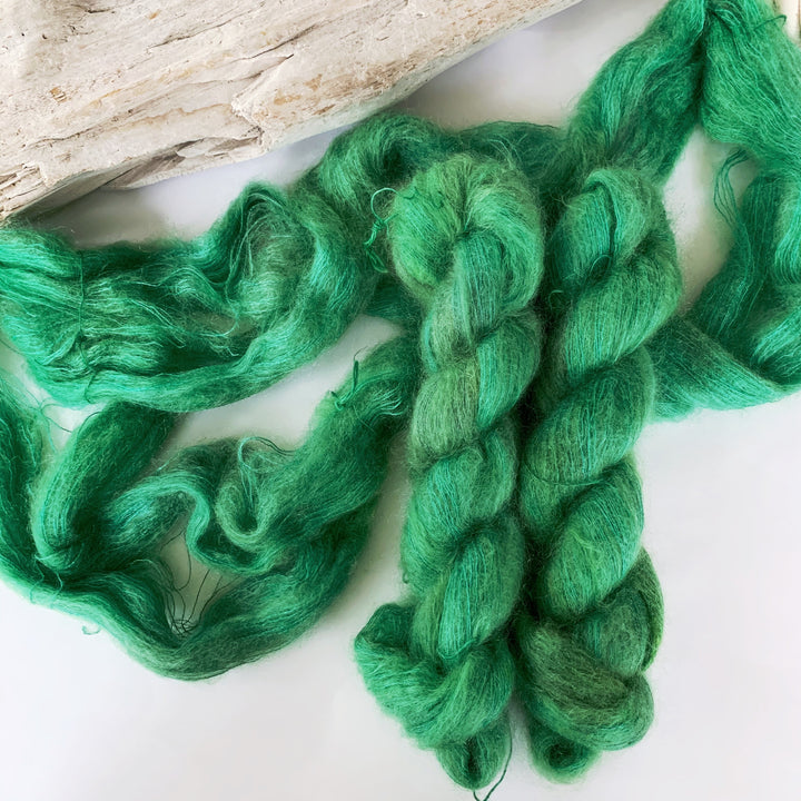 Skeins of bright green mohair yarn.
