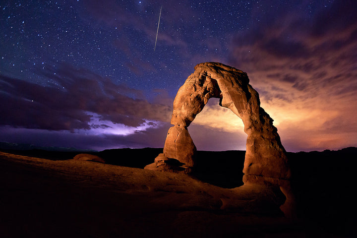 Arches National Park under a starry sky.