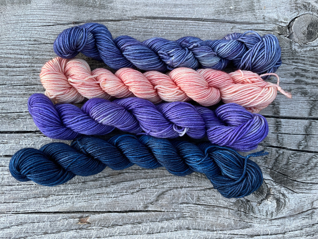 Blue, purple and pink mini skeins of yarn.