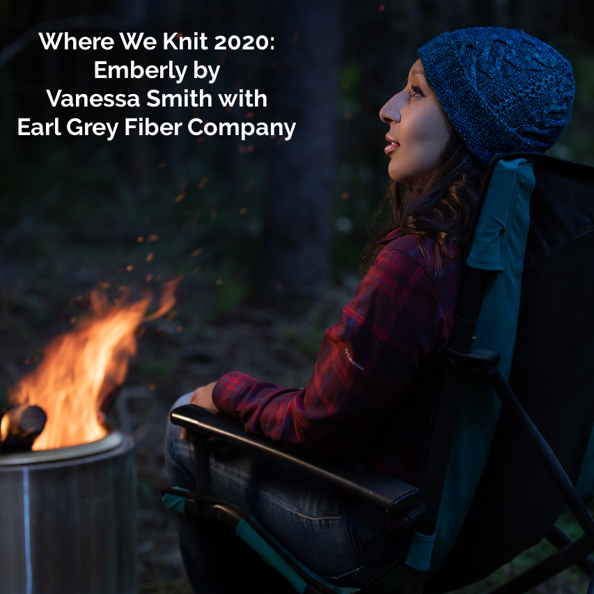 A woman wears a blue cabled hat by a fire and the words Where We Knit 2020 Emberly by Vanessa Smith with Earl Grey Fiber Company