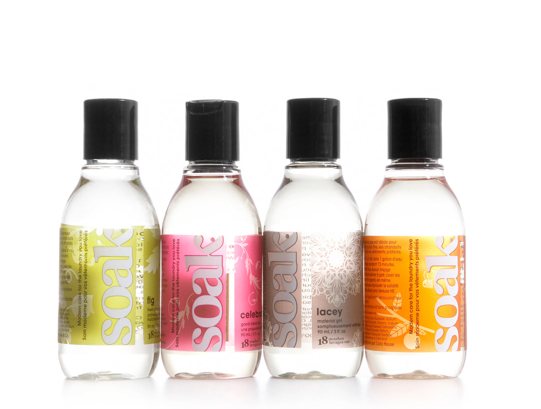 Clear bottles with green, pink, brown and orange labels that read Soak.