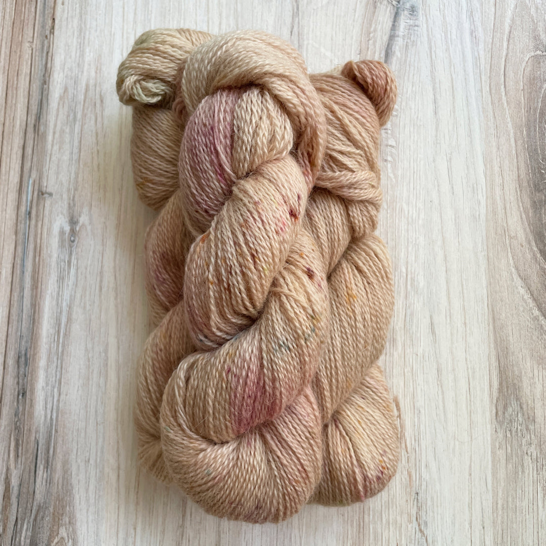 Peach yarn speckled with pink.