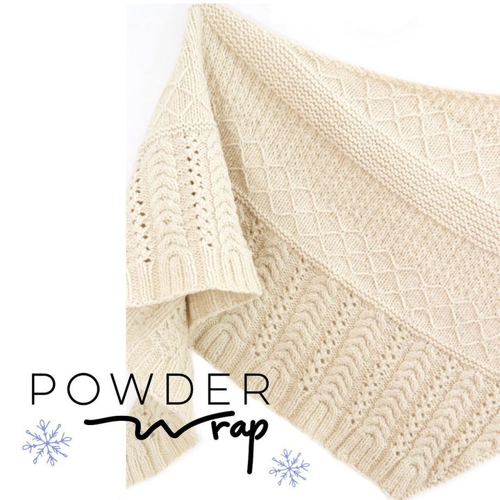 A cream colored textured shawl and the words Powder Wrap.