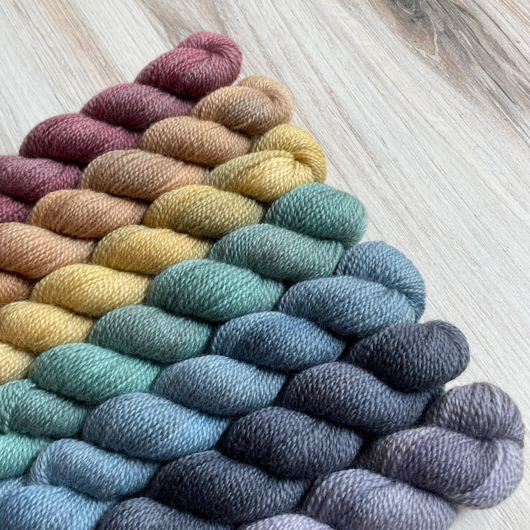 A rainbow of mini skeins of yarn.
