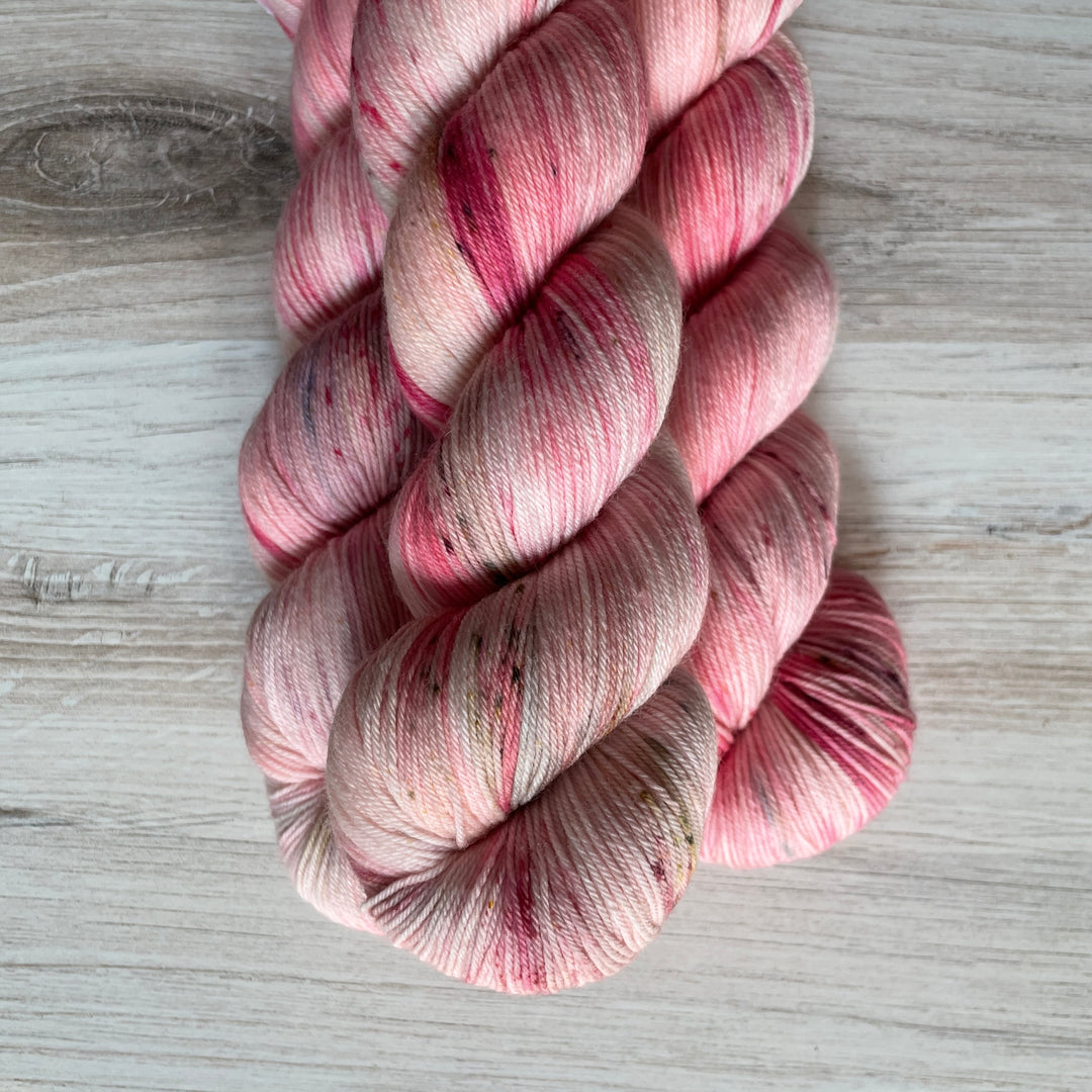 Pale pink yarn speckled with bright pink.